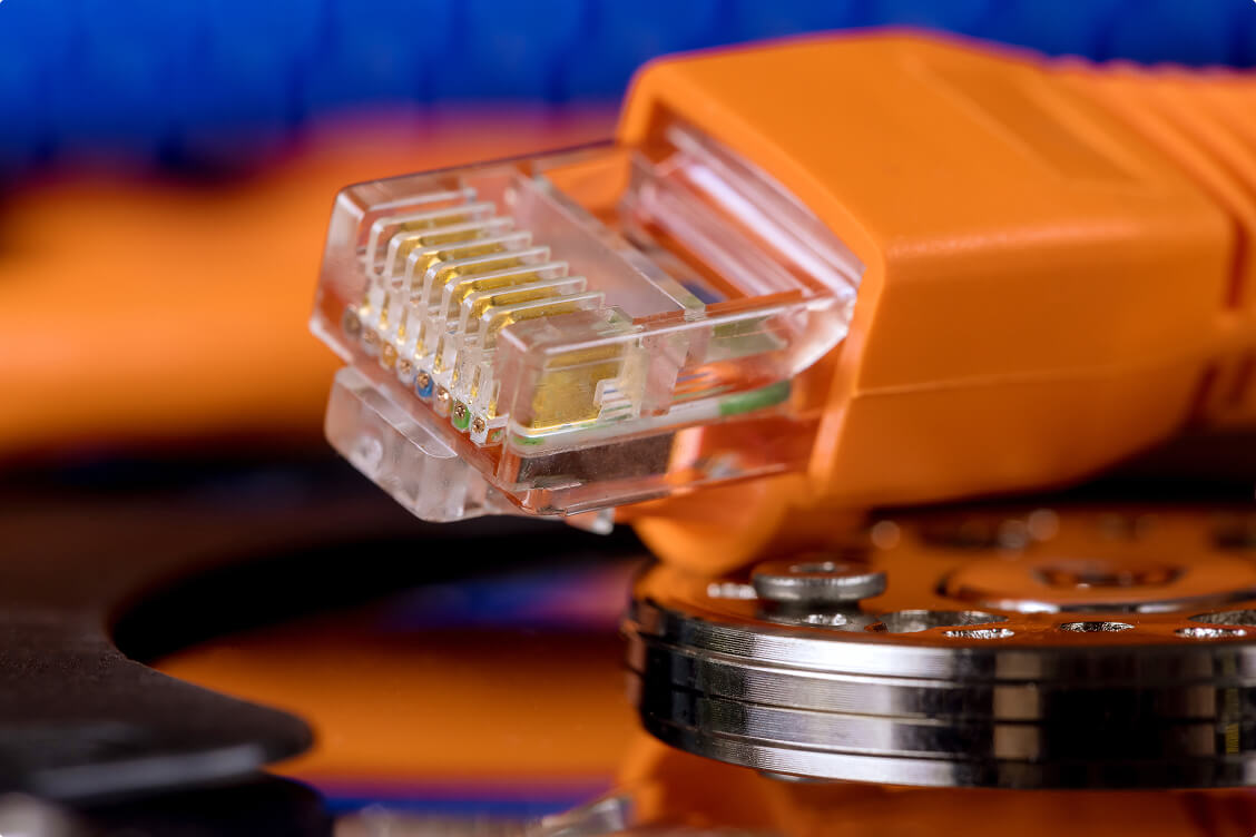 Close-up of an orange Ethernet cable with RJ45 connector symbolizing high-speed internet and network connectivity.