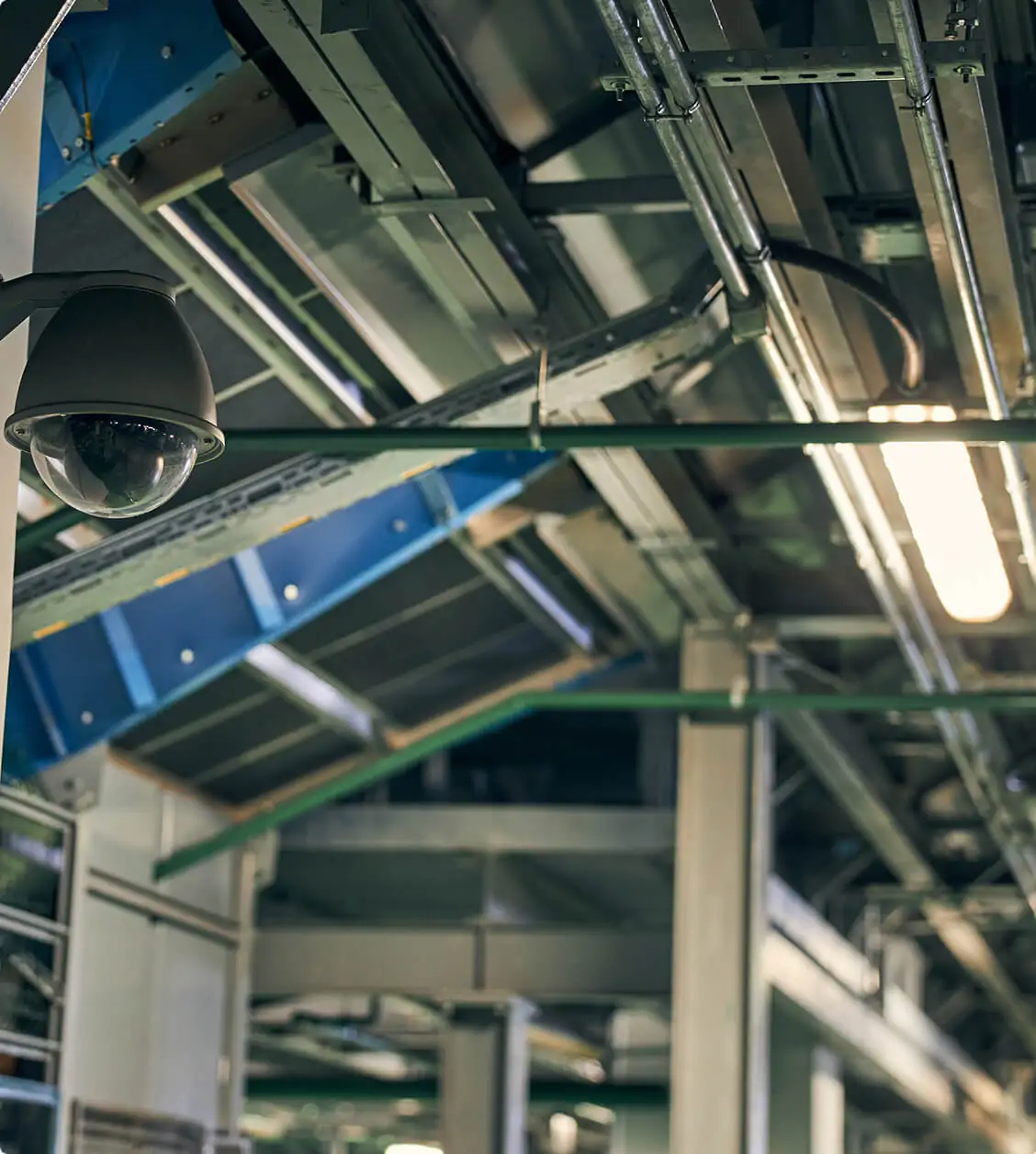 Industrial dome security camera installed inside a factory ceiling for workplace surveillance and safety monitoring.